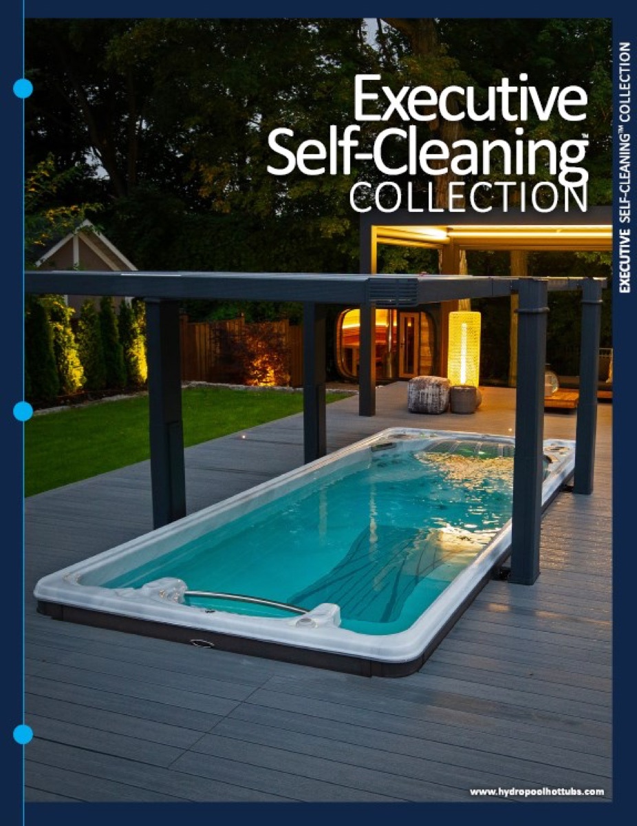 Hydropool Executive Self-Cleaning swim spa installed on a backyard deck with pergola at dusk