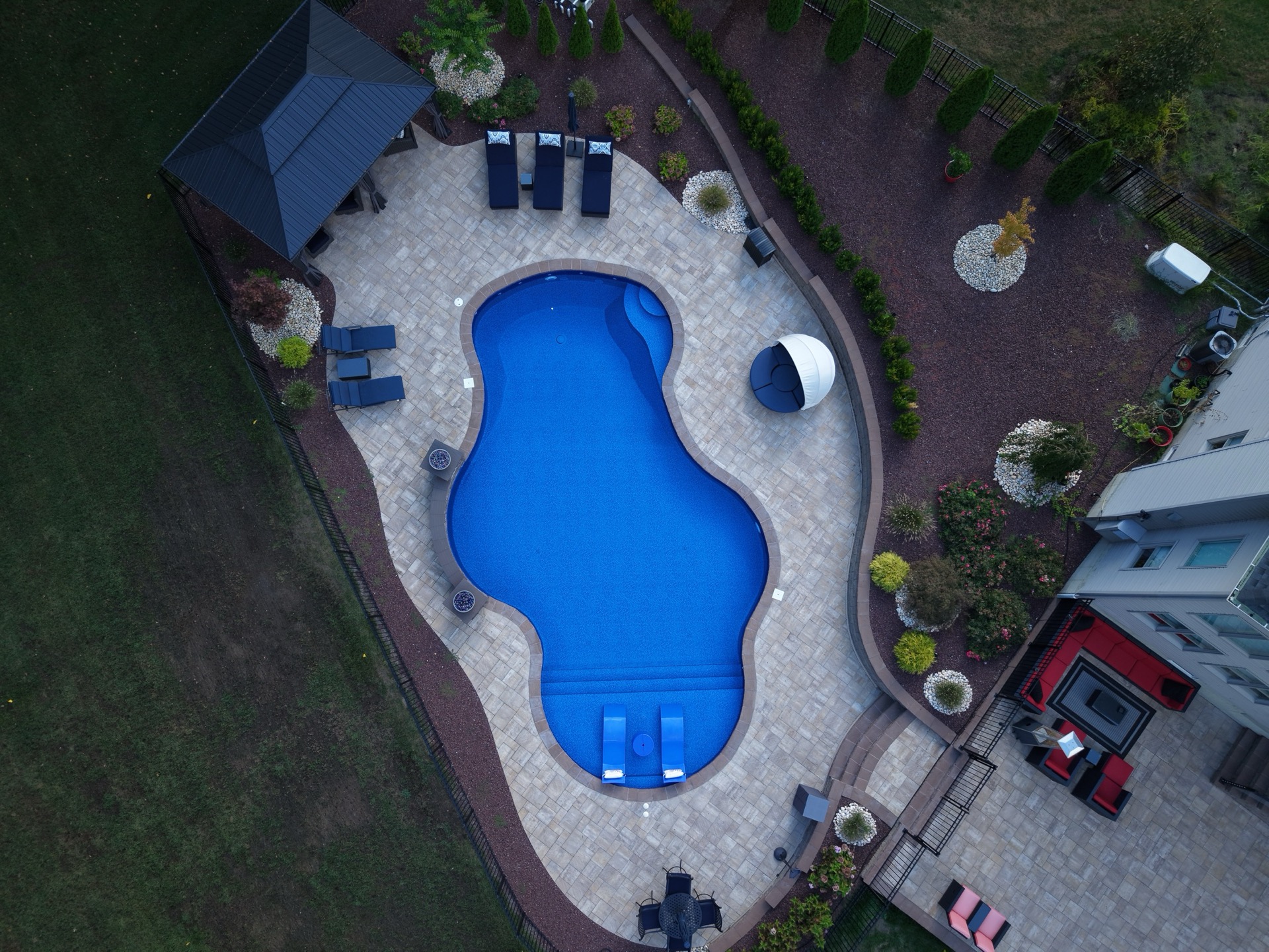 Aerial view of a clean, sparkling Seasonal World pool with freeform design and waterfall