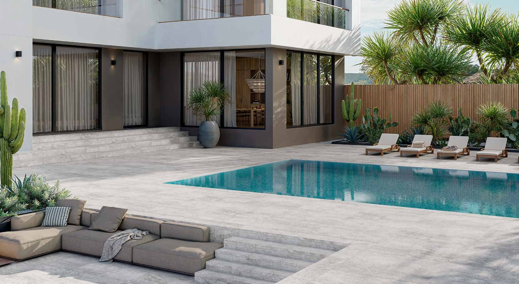Del Conca porcelain pool deck — travertine-look pavers in residential daylight, full pool view with lounge chairs and modern home