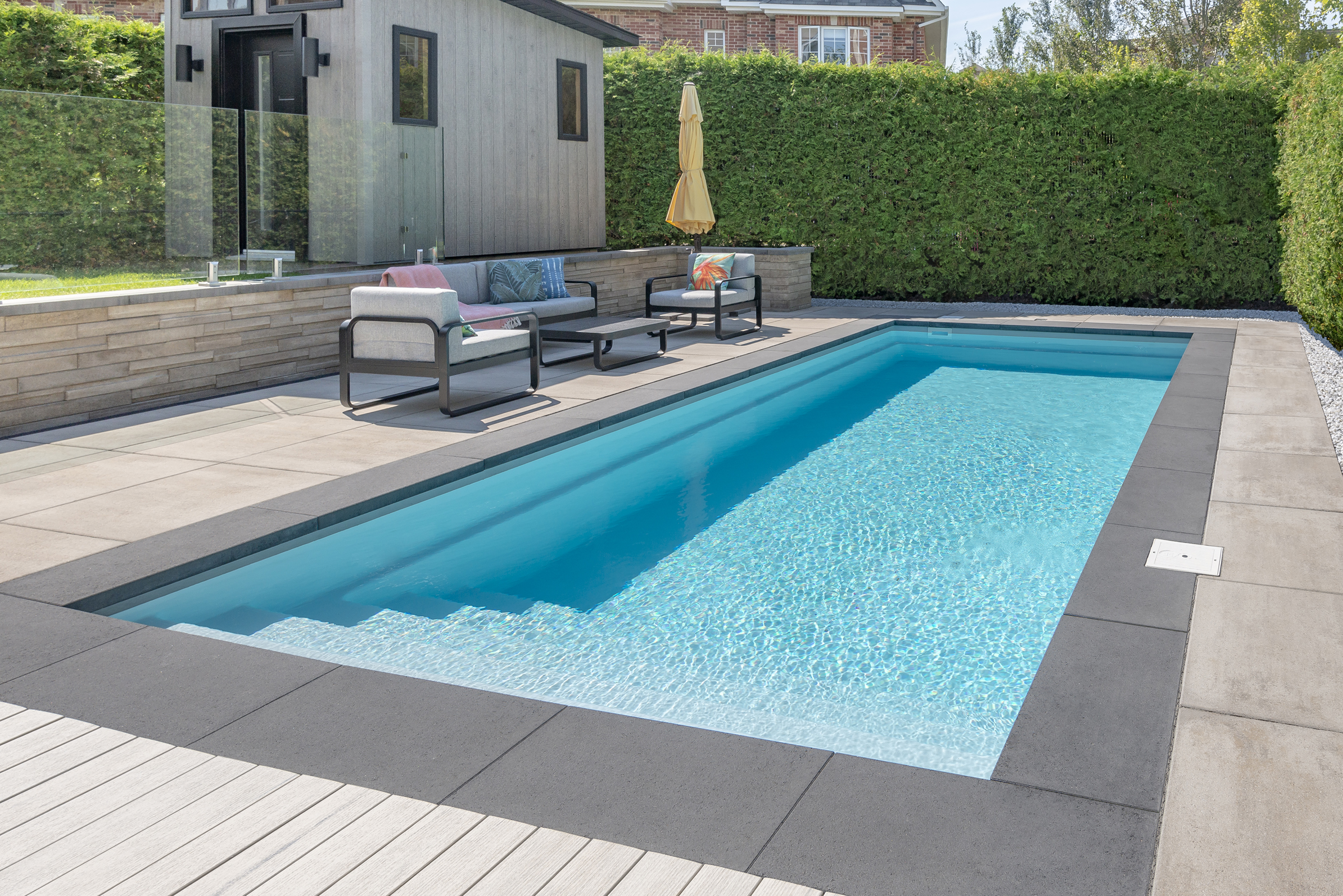 Rinox PROMA XL paver coping in caviar finish around an Azoria fiberglass pool