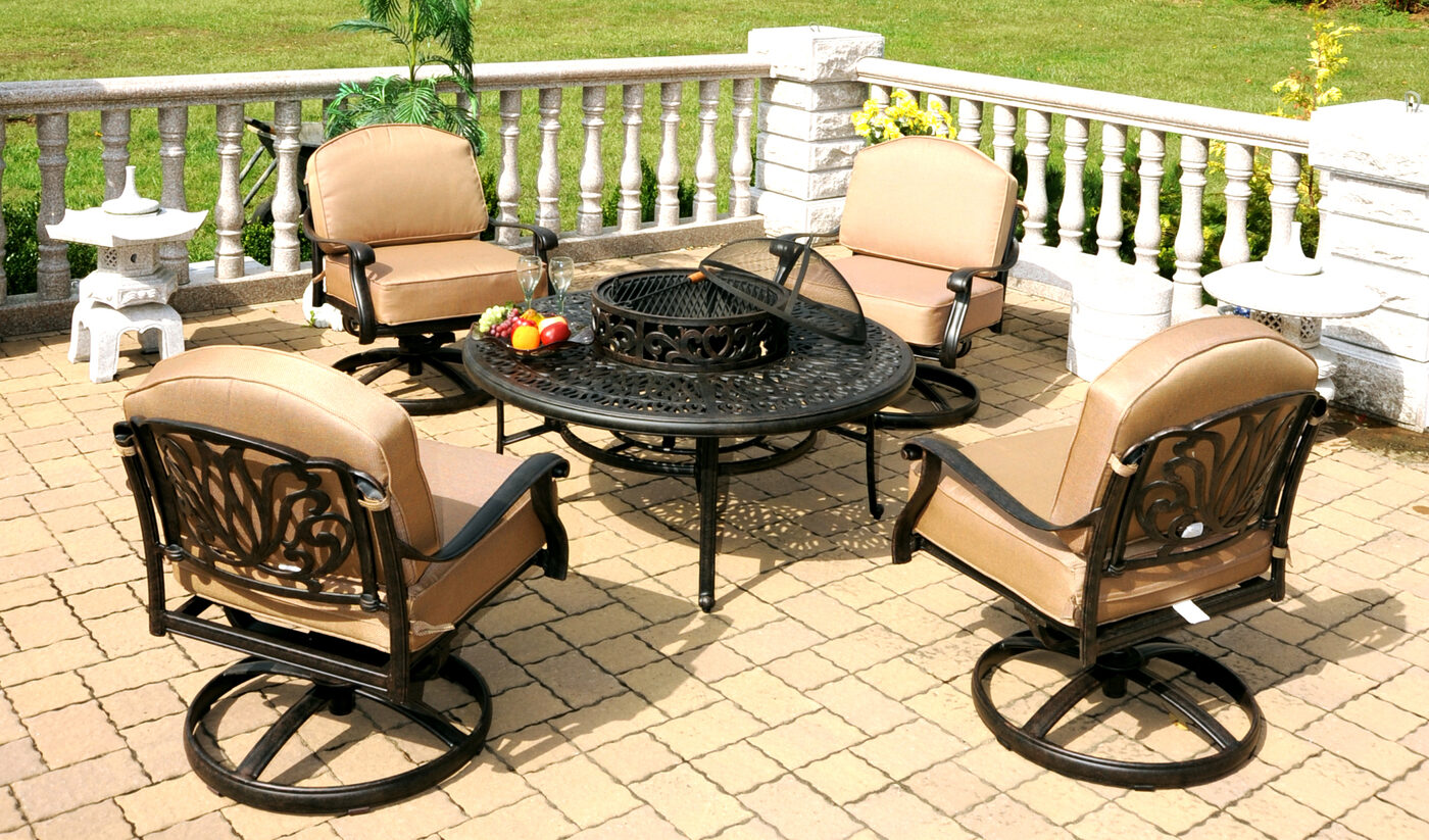 Outdoor patio furniture set with cushioned chairs and sectional under a pergola