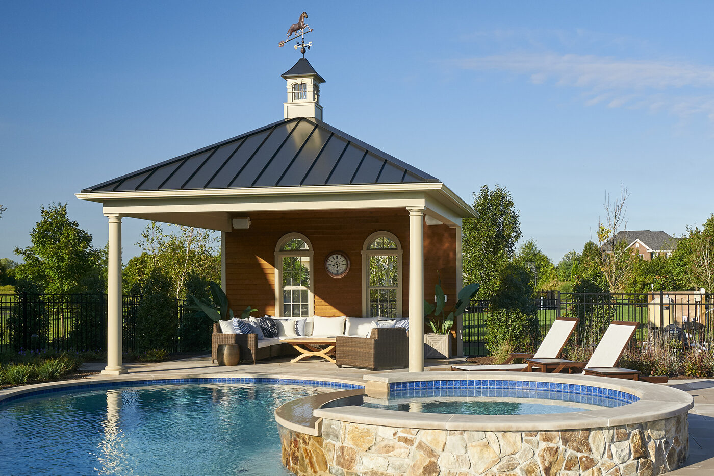 Homestead Belmar pavilion with partial-enclosure back wall, vinyl siding, and architectural shingle roof beside a pool