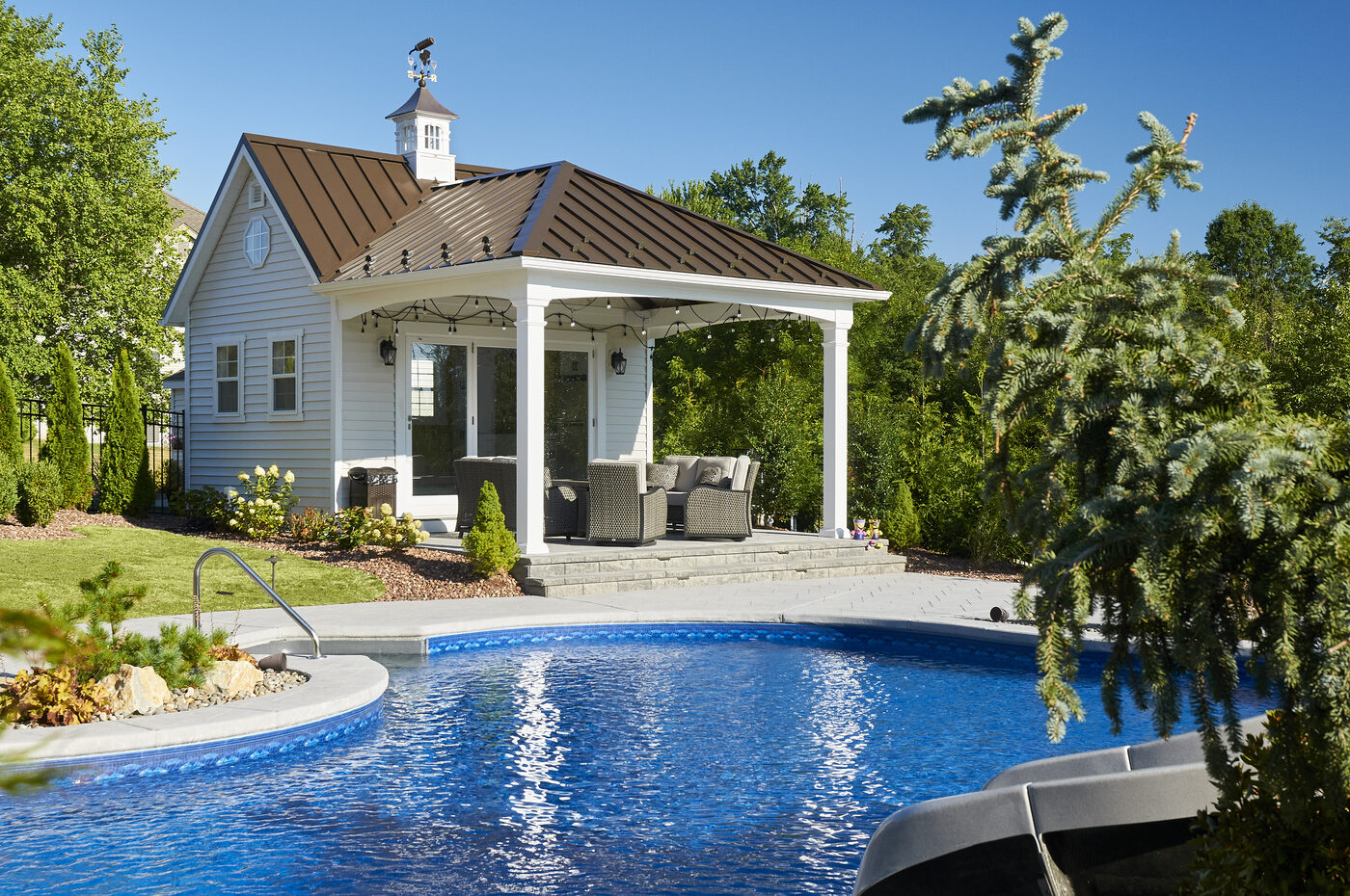 Custom luxury Homestead pool house with brick veneer, harvard slate shingles, double 15-lite doors, full residential interior with kitchen and bathroom