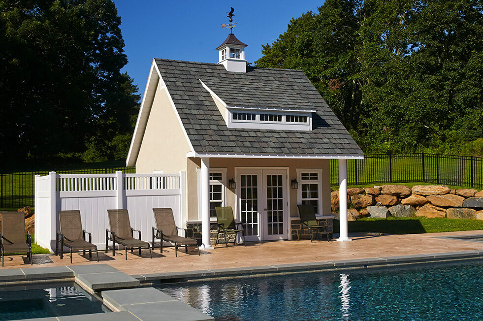 Homestead Heritage pool house with white siding and covered porch