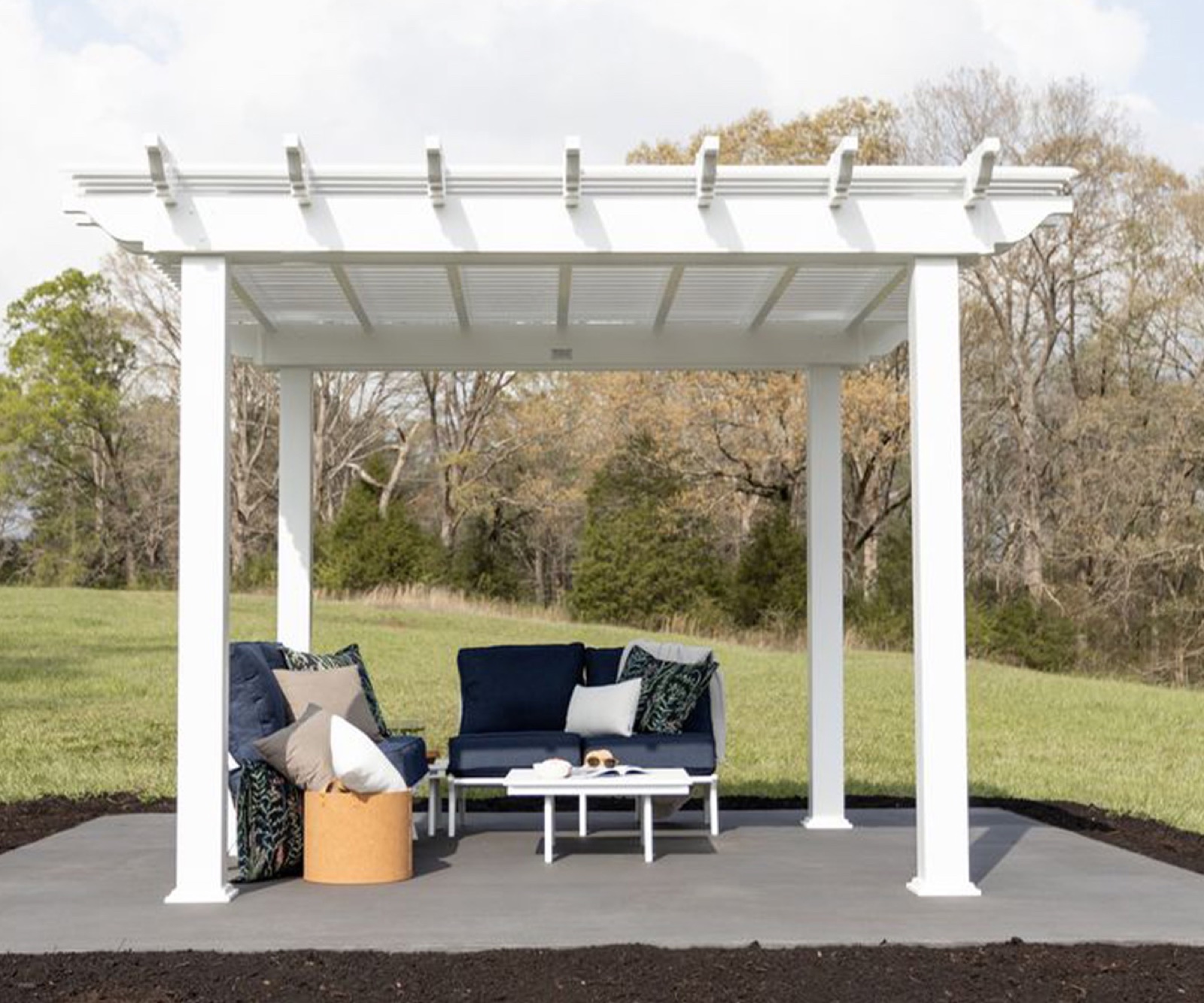 Berlin Gardens Bradford vinyl pergola in white covering an outdoor seating area