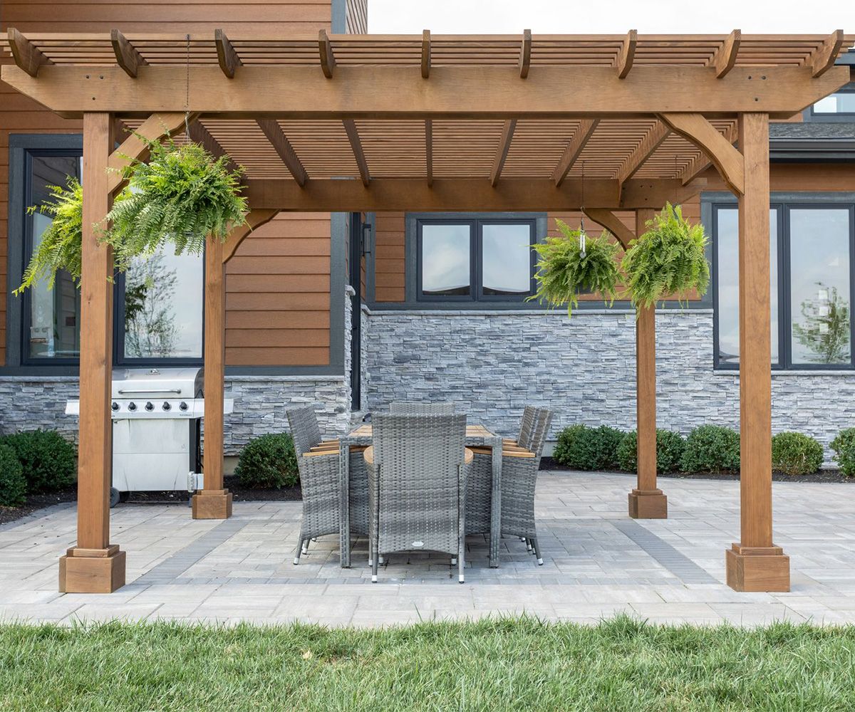 Berlin Gardens Outback pergola in cedartone with arched braces and classic end caps