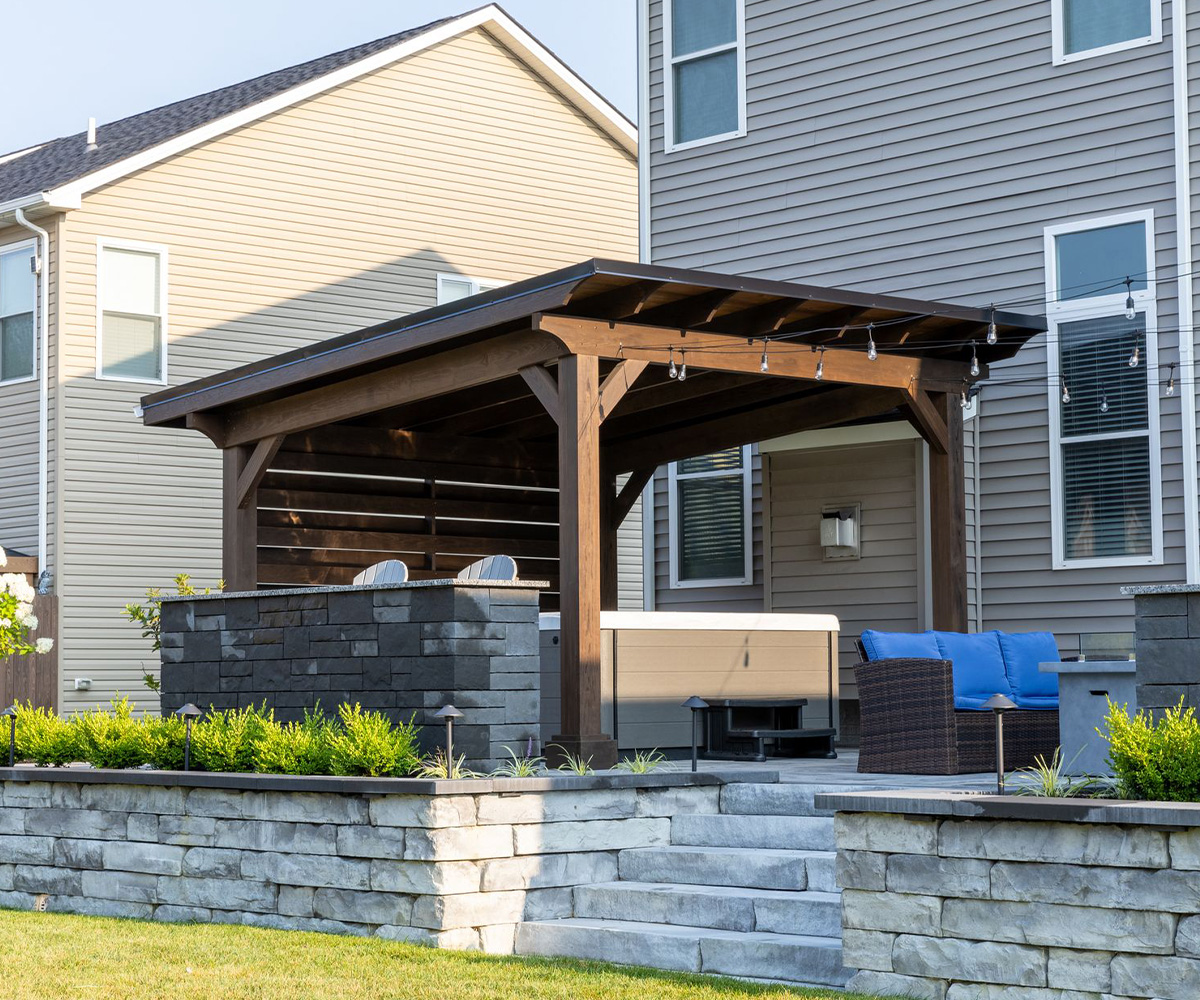 Berlin Gardens Prairie pavilion in mocha stain with open eave roof and horizontal privacy wall